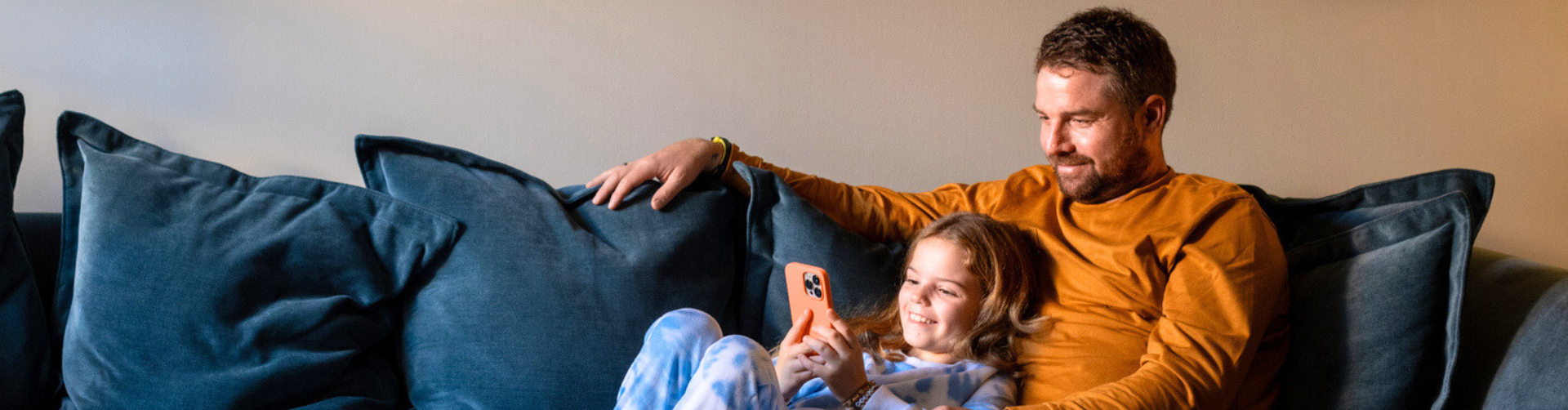 father and daughter relaxing on couch