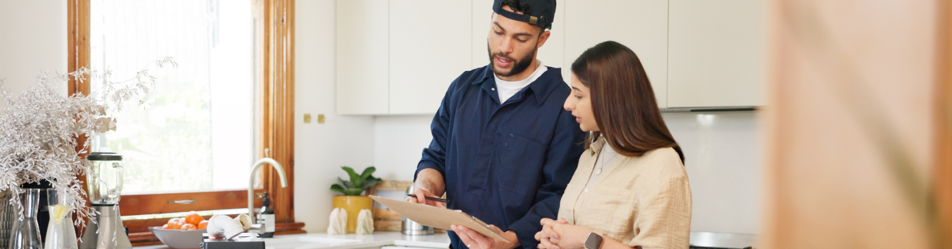 contractor talking with homeowner in kitchen